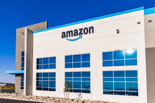 Amazon fulfillment center in blue accent beneath the intense sun.