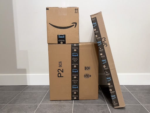 Several Amazon parcels stacked up together.