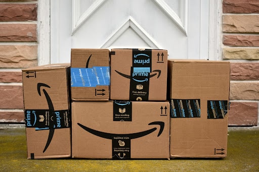 Amazon parcels neatly piled up in front of a doorstep